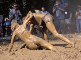 Man and women mud wrestling