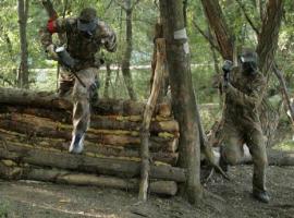 Two running paintball players